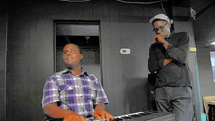 Shailen Abram, 14, of the East Hills plays the keyboard as the Rev. Tim Smith watches. Rev. Smith is executive director of the Center of Life.