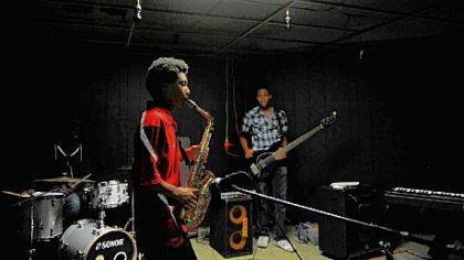 Ellis Durham, 14, of Monroeville plays the saxophone; David Watkins, 16, of Forest Hills plays bass guitar at the Center of Life in Hazelwood. The outreach has four jazz bands and an ensemble of rappers, dancers and singers.