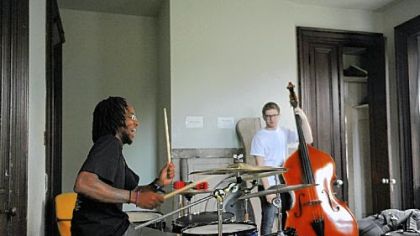Julian Powell, 22, of Braddock is on drums and Sam Harris, 18, of Point Breeze plays the bass. Performers earn and keep track of money as part of the outreach effort of the Center of Life.
