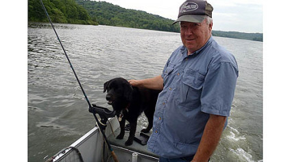 The lake has changed. With his dog Suzi, Jim Burr, president of Three Rivers Muskies Inc., guides a musky trip at Lake Arthur.
