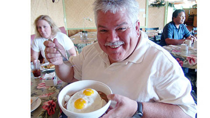 Rick Sebak shows off a bowl of "loco moco," featured in the new documentary "Breakfast Special 2: Revenge of the Omelets."