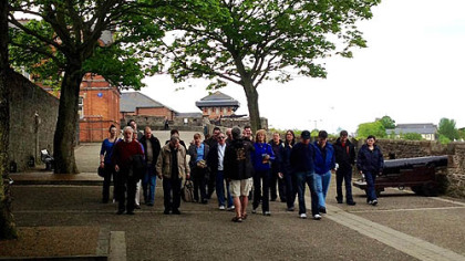 Tourists walk along the circumference of Derry's walled city, the only remaining completely intact walled city in Ireland. Built in the early 1600s, it was blocked only two decades ago by barbed wire and British soldiers.