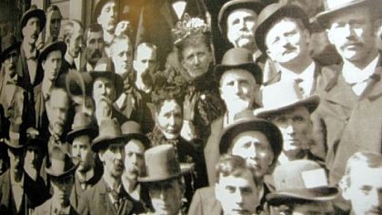 Vintage photograph of William McKinley shows him surrounded by supporters gathered on the front porch of his home in Canton, Ohio. The image, blown up to life-size, is on display in the McKinley Museum and Library