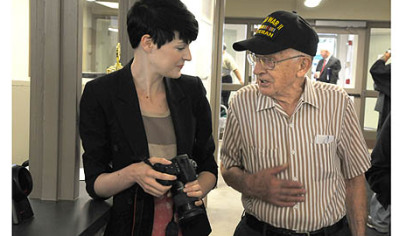 Al Kopycinski, 88, of the Southside chats with Amanda Swadlo, a graphic designer with Zoltun Design Studio, as she pauses while taking photos of the remodeled interior of the South Side Market House. Zoltun is across the street from the historic building.