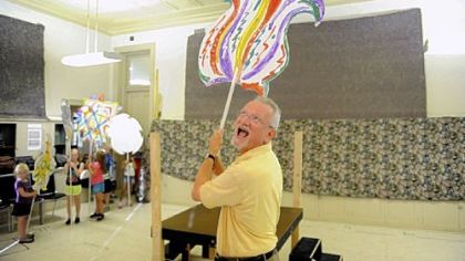 Director Jonathan Eaton waits while a group of 6- to 8-year-old children from Shady Side Academy don their masks during a rehearsal of the Opera Theater's production of Mozart's "The Magic Flute" at the Foster Center in Lawrenceville.