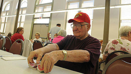 David Stipe, 81, of the South Side makes himself at home with a deck of cards today at the South Side Market House.