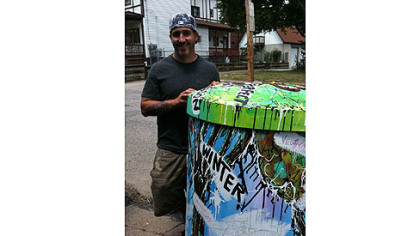 Chris Galiyas is one of 10 artists chosen to paint a rain barrel for installation in public places throughout the city.