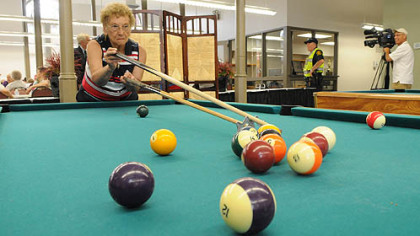 Phyllis Haduch of Mount Washington takes her shot while playing pool Monday with Francis Szewczyk after the reopening of the historic South Side Market House.