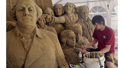 Martijn Rijerse, an artist with Sandsational, works on a sand sculpture of the signing of the Declaration of Independence, in Point State Park.