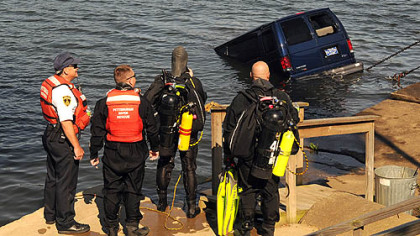 City of Pittsburgh River Rescue team members watch as the towing crew pulls the van from the Ohio River.