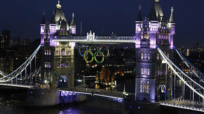 The Olympic rings are seen atop the iconic Tower Bridge in London coinciding with one month to go until the start of London 2012 Games, Wednesday evening, June 27, 2012. The giant rings, which are fully retractable to allow for tall ships to pass through the bridge, will remain in position for the duration of the Games.