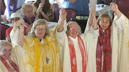 Women ordained as priests and deacons celebrated during a ceremony aboard a riverboat on the Monongahela River in 2006. Among them was Joan Clark Houk, center, shown with Gisela Forster, left, and Eileen McCafferty DiFranco.