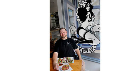 Adam Manculich takes a break in the front window of Yo Rita's.