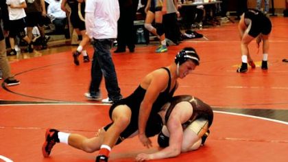 North Allegheny's Alex DeCiantis, left, has a choice to make on which sport to play in college: wrestling or football.