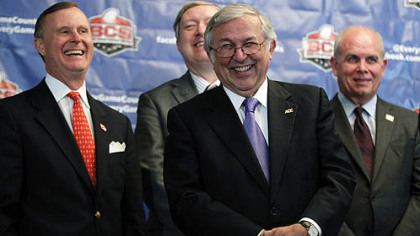 Charles Steger, center, president of Virginia Tech, smiles with Gary Ransdell, left, president of Western Kentucky, Duane Nellis, president of Idaho, and Bernie Machen, president of Florida, during a media availability Tuesday after a BCS presidential oversight committee meeting, Tuesday. A committee of university presidents approved the BCS commissioners' plan for a four-team playoff to start in the 2014 season.