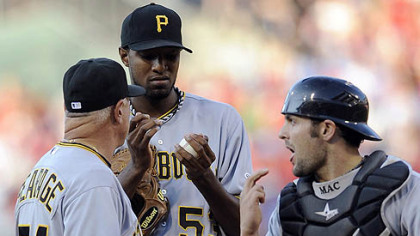 Pirates pitcher James McDonald talks to Ray Searage and catcher Michael McKenry after the Phillies' Carlos Ruiz hit a home run in the first inning.
