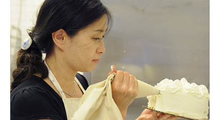 Sumi Chun puts the finishing touches on a sweet potato cake at her Sumi's Cakery in Squirrel Hill.