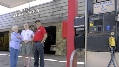 Dorothy Genser, 90, poses June 19 with her sons Ron Genser, center, and Rick Genser at the family-owned gas station, Mike's Service Station, on Route 8 in Shaler. Partly because government regulations have become too costly, the Gensers will stop selling gasoline at the end of June at the station that has been in their family since 1928. They plan to continue operating A-Advantage Truck & Trailer, the service and parts businesses housed at the gas station, as well as the A-Advantage Gun Shop.