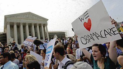 Supporters of President Barack Obama?s health care law celebrate Thursday outside the Supreme Court in Washington.