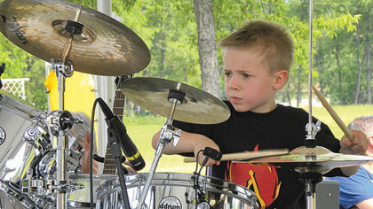 Five-year-old drummer Avery Molek keeps the beat.