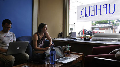 Henry Gruber and Julia Friedman put up this sign Thursday at the Obama campaign headquarters in Pittsburgh.