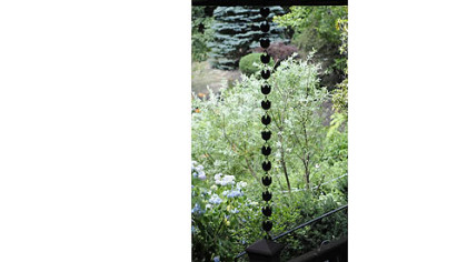 A Japanese rain chain hangs from the deck in Jerry and Monica Segal's garden.