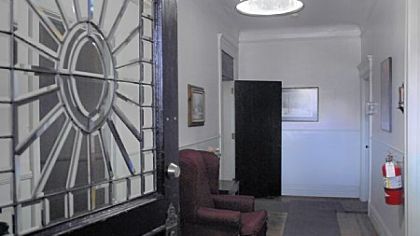 Many all of the period details remain in this Victorian home, including the original arched front door with leaded-glass panels.