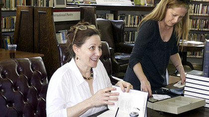 Sandy Lerner, seated, an expert on Jane Austen, signs copies of her book after a talk at the Carnegie Library in Oakland Saturday.