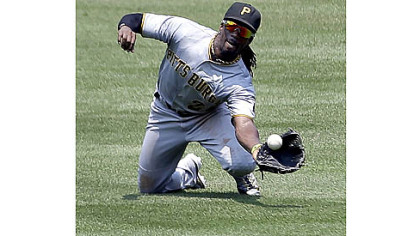 Andrew McCutchen dives for a ball hit by St. Louis' Carlos Beltran in the third inning Saturday in St. Louis. McCutchen later left the game with a sprained wrist and is listed as day-to-day.