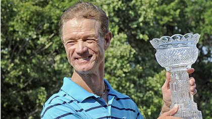 Joe Daley holds trophy after sinking a birdie putt on the 18th green to go 14 under and win the Constellation Senior Players Championship Sunday at Fox Chapel Golf Club