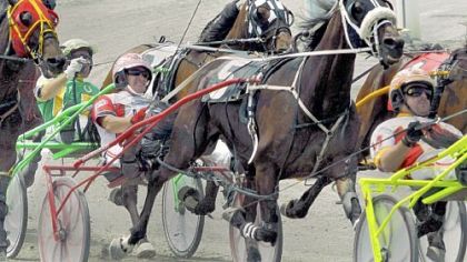 Dave Palone, center, driving Smartiscape (5), tries to hold onto his position in the pack of horses during a June race at The Meadows Racetrack and Casino in Washington.