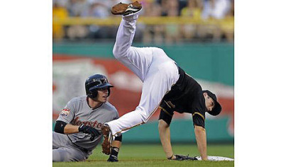 Astros third baseman Scott Moore tags out Pirates Casey McGehee.