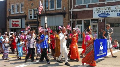 Immigrant and refugee students from the Greater Pittsburgh Literacy Center marched in Brentwood's Fourth of July parade on Wednesday. Many were wearing the clothes and carrying the flags of their native countries.