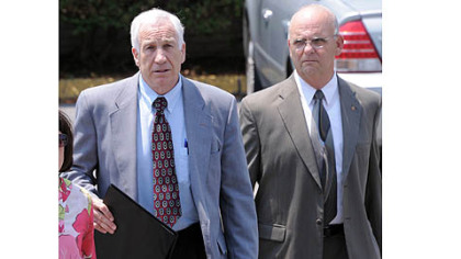 Jerry Sandusky leaves the Centre County Courthouse after the jury began deliberating his case. At right is Centre County Sheriff Denny Nau.
