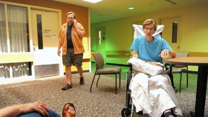 Dan Yablonsky, 23, speaks with the Post-Gazette from HealthSouth Harmarville Rehabilitation Hospital Monday as his mother, Fran, left, listens and his father, Bud, center, takes a phone.