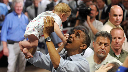 President Barack Obama lifts 9-month-old Nathan Maxwell Johnson of Youngstown into the air after speaking at a campaign event at Dobbins Elementary School in Poland, Ohio this morning.