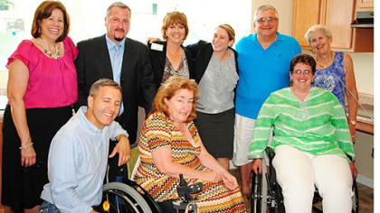 The Accessible Dreams development team with the Liadis family in their new accessible kitchen. In front, from left, are Duane Fauth, director of construction services, Accessible Dreams; Kathleen Kleinmann, CEO, TRIPIL; and Valerie Liadis. In the back row, from left, are Cindy Bodnar, director of housing services, Accessible Dreams; Richard Zatta, ADA consultant, Accessible Dreams; Lucy Rooth, executive director, Accessible Dreams; Bridget Coyne, attorney, Regional Housing Legal Services; and Thomas and Catherine Liadis.
