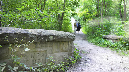 Pedestrians walk past a bridge built by the WPA in 1939 in Schenley Park.