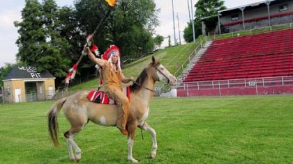 The Quips' mascot, waving his flaming spear, rides his horse on the field at Carl Aschman Stadium in Aliquippa.