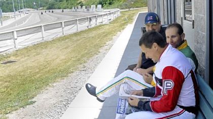 Dave Palone, foreground, relaxes before a race at The Meadows with fellow driver Mike Wilder, center, and his friend Tim Caputo.