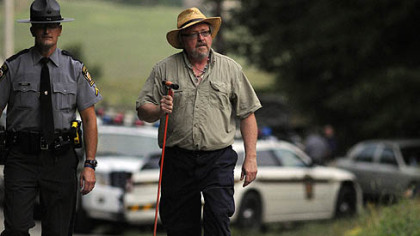 State Trooper Joseph Christy and Dennis C. Dirkmaat, right, director of applied forensic sciences at Mercyhurst University, come up from the staging area in North Union, where they were searching for the remains of Jennifer Marteliz, 7.