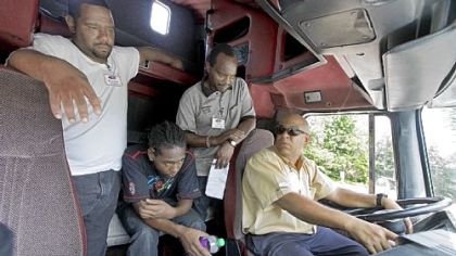 Instructor Victor Torres, right, goes through the steps of a safety inspection during a class Wednesday at the Carolina Trucking Academy training school in Raleigh, N.C.