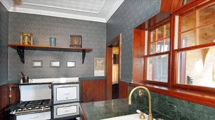 The kitchen features updated wooden cabinets and marble countertops.