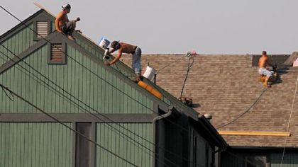 A crew from Interthal Roofing works atop a shopping center along Route 8 in Richland. Because of the severe heat, owner Fred Interthal said, the crews start their job at 5 a.m. and work only until noon. They also sit on foam pads to insulate them from the heat of roof shingles.
