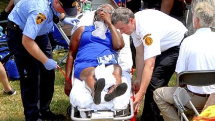 Paramedics treat an attendee for heat exhaustion at President Barack Obama's rally at Carnegie Mellon University on Friday. About 200 people at the rally sought medics because of the heat, with 13 being transported to local hospitals for treatment.