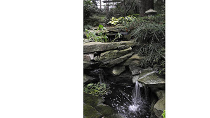 Water splashes over a stone stream built by John Polena in his Mt. Lebanon garden.