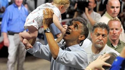 President Barack Obama lifts 9-month-old Nathan Maxwell Johnson of Youngstown into the air Friday after speaking at a campaign event at Dobbins Elementary School in Poland, Ohio.