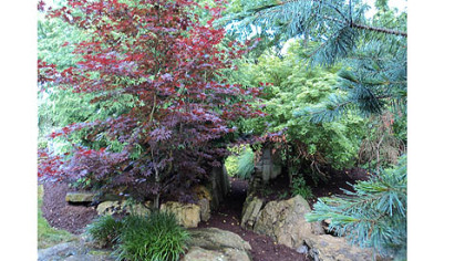 A stone arch is in the garden of Gary and Barb Dinsel.