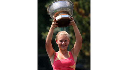 Anna Smith of Peters hoists the trophy after winning the Women's ITA National Collegiate Clay Court Championships Saturday at the Mt. Lebanon Tennis Center.