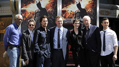 "The Dark Knight Rises" director Christopher Nolan, fourth from left, poses Saturday with cast members at his hand and footprint ceremony at Grauman's Chinese Theatre in Los Angeles.